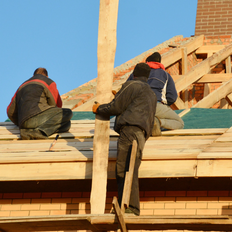 three people working on the residential re roofing process